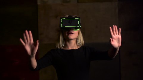 Virtual reality game. Girl uses head mounted display. Slow motion