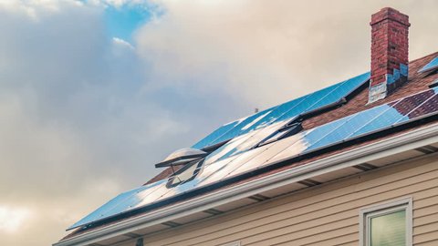 Solar panels on roof of residential house, clean green energy timelapse