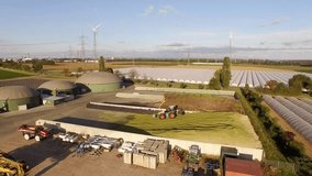 aerial video footage of a biogas plant with 3 fermenters in germany