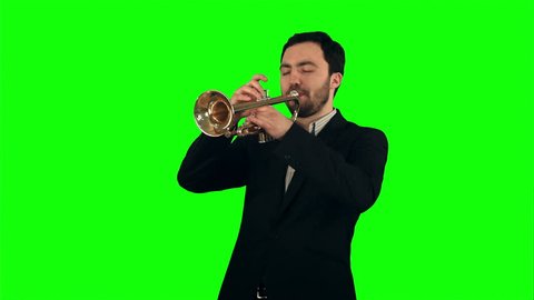 Young musician playing trumpet on a Green Screen, Chroma Key. Professional shot on BMCC RAW with high dynamic range. You can use it e.g in your commercial video, business video, office theme.