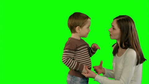Photo of the happy young family with children looking up on a Green Screen, Chroma Key. Professional shot on BMCC RAW with high dynamic range. You can use it e.g in your commercial video, family video