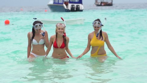 Group Of Best Women Friends Walking Out Of The Ocean After Snorkeling