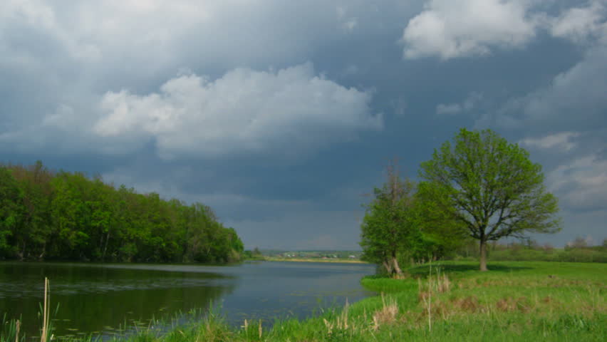 timelapse with storm clouds moving over lake