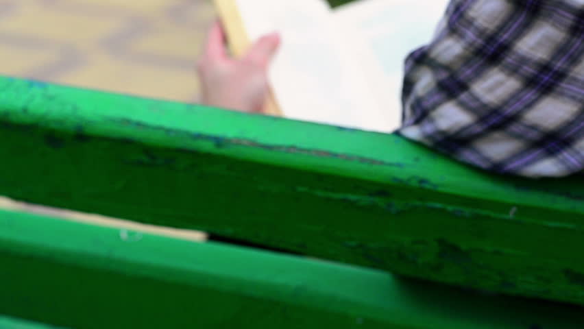 Girl reading a book in a foreign language. Close up