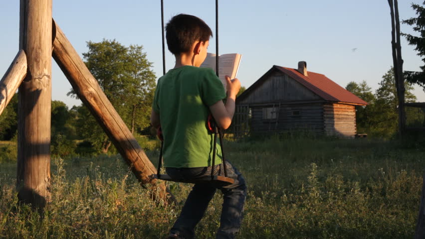 The boy reads the book. Summer