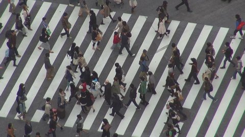 TOKYO - 10 APRIL 2012, Aerial view of commuter cross a busy avenue by day Editorial Stock Video