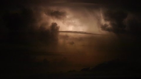 Spectacular extensive lightning strikes during a huge thunderstorm in the night sky with storm clouds