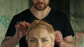The hairdresser does a hairdress to a blond girl. Professional shot on BMCC RAW with high dynamic range. You can use it e.g in your commercial video, hair salon presentation, music video.