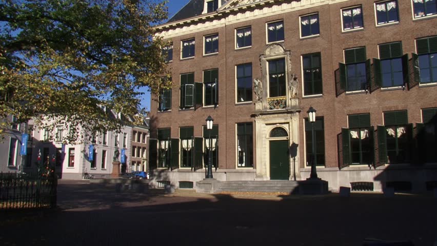 LEEUWARDEN, THE NETHERLANDS - OCT 2015: Old city hall + cyclist + tilt up. Built in 1715 and beautifully restored, still in use for weddings. Leeuwarden will be  European Capital of Culture in 2018.