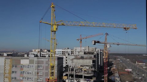 Construction of a concrete building in the background tower crane