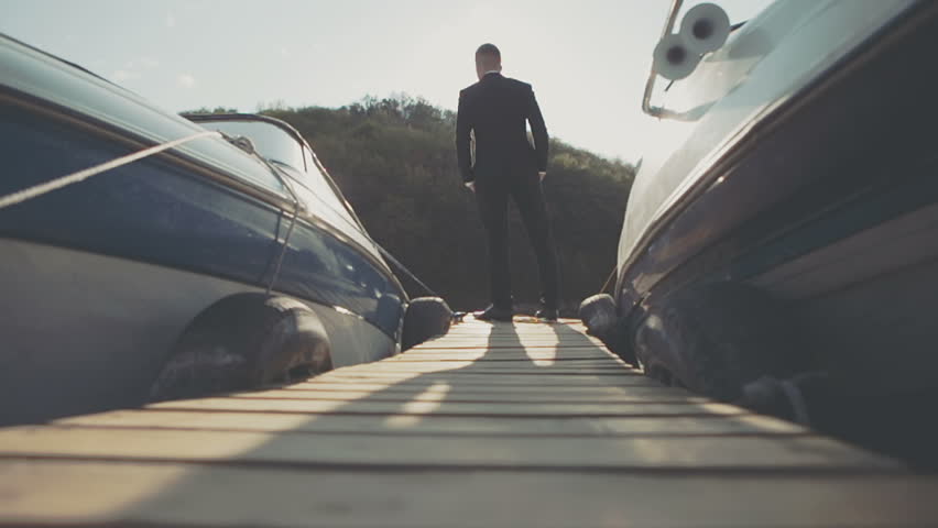 Young businessman goes past the front light boat