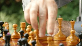 Elderly man playing chess in the park slow motion - Powered by Shutterstock - Get 15% off with code: PIKWIZARD15