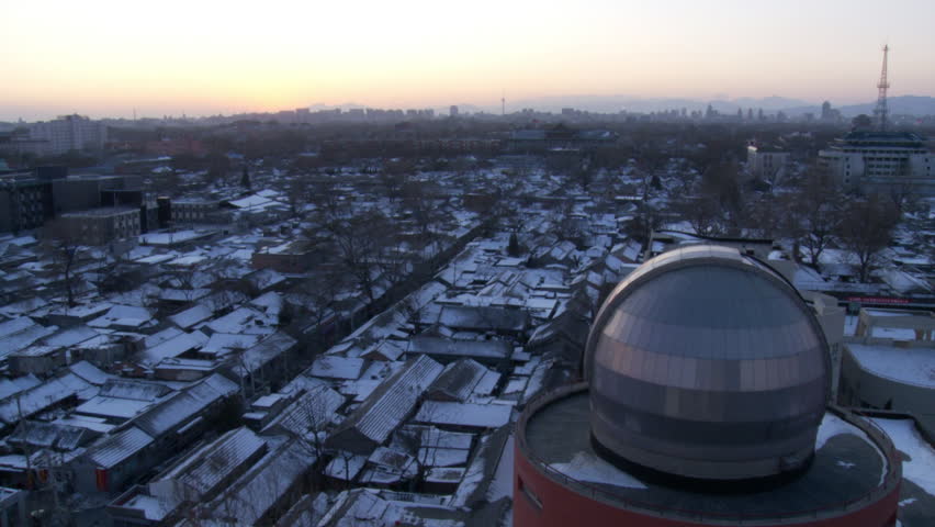 Beijing, China - January 2010: Evening skyline of snow covered courtyards and rooftops of a Beijing hutong. China.