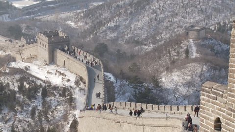 Beijing, China - January 2010: People walking along the Great Wall at Badaling after snow. Beijing, China.