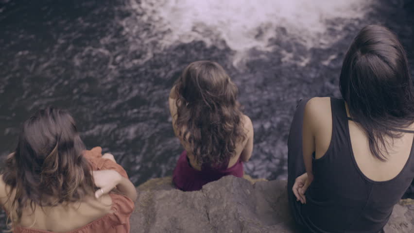 3 Young Women Sit And Watch Waterfall From Cliff, Dreamlike Fantasy (4K) 