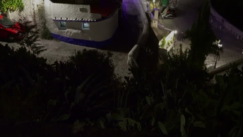 Granada, Andalusia, Spain - Oct 11, 2015. Panning up shot of the Sacromonte district at night. Sacromonte is famous for it