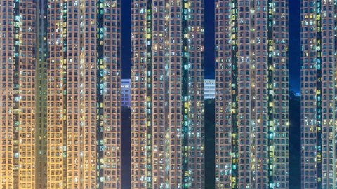 4k timelapse video of residential apartment buildings from day to night, camera zooming in
