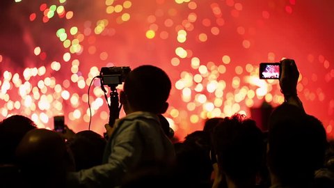 Watching Fireworks silhouetted crowd. Holiday backgrounds. Fireworks in the sky celebrating lunar new year... >>> Please search more: " FireworksCollection ".の動画素材