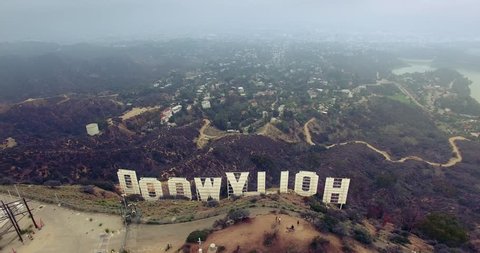 LOS ANGELES - October 2015: Aerial view of Hollywood Sign over LA cityscape on a gloomy day. 4K UHD.