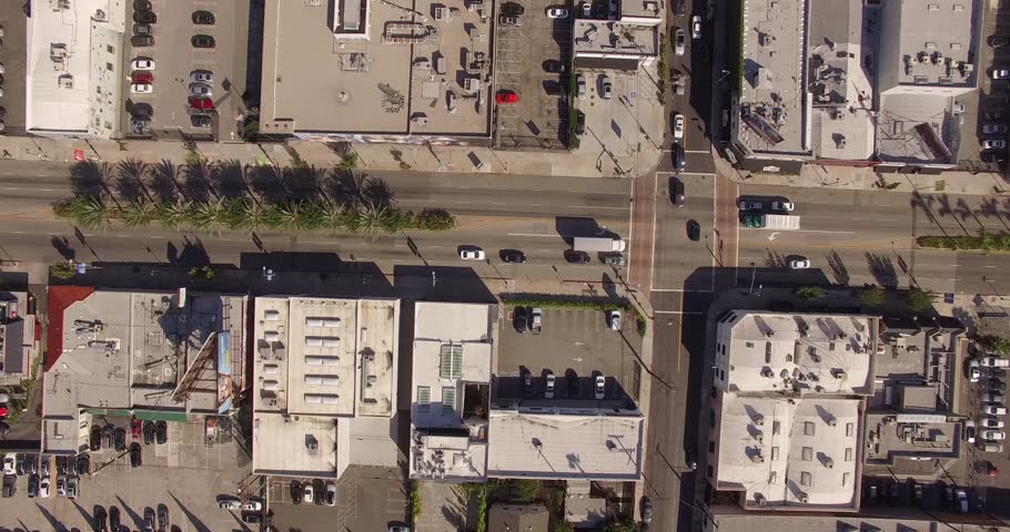 Vertical aerial top down view shot rotating, descending and looking down on street traffic in Los Angeles, California. 4K UHD.