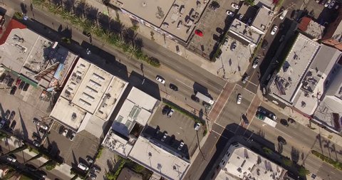 Vertical aerial top down view shot rotating, descending and looking down on street traffic in Los Angeles, California. 4K UHD.