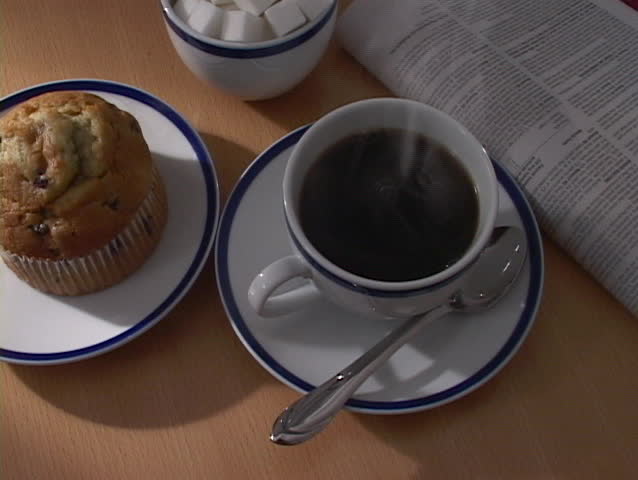 Steaming cup of coffee on the table