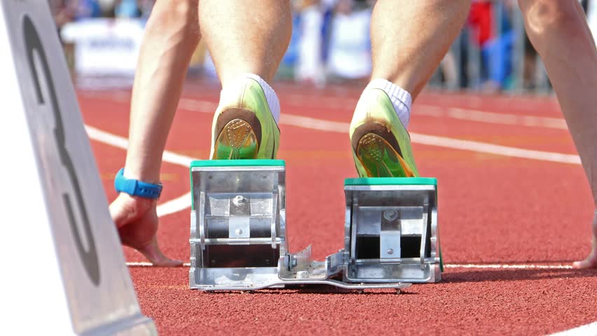 Low perspective clip of a runner, starting out of the block.