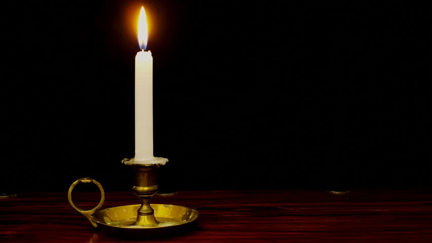 Timelapse of candle burning down in old fashioned brass candle holder