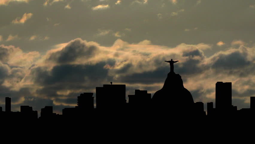 Rio de Janeiro, Brazil, with the statue of Christ, and the cloudy sunset in the background.