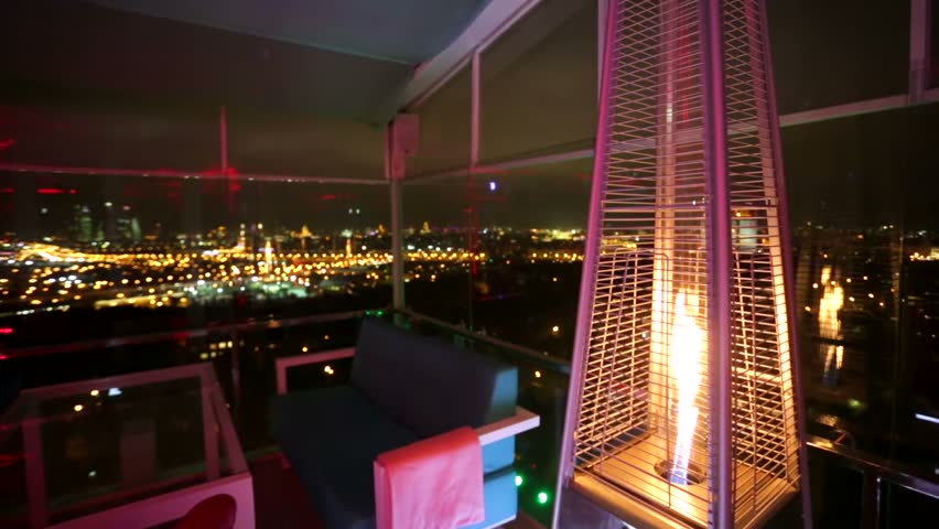 MOSCOW, RUSSIA - OCTOBER 14, 2015:  Cozy fire inside Extra Lounge Moscow nightclub with an observation deck of night city. | Shutterstock HD Video #12314864