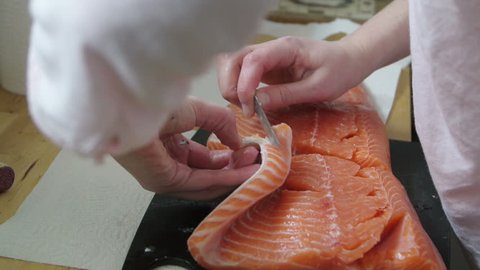 Close-up view of chief cutting organic red salmon filet for food for gourmet food preparation Adlı Stok Video