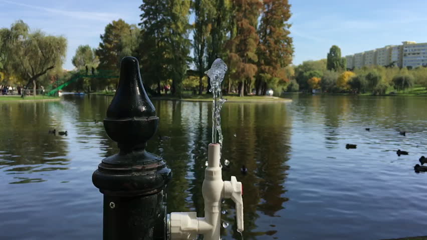 Water from a public water fountain, in slow motion. Video was made in autumn in a beautiful sunny day, in october 2015