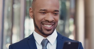 Portrait of African American Businessman smiling outside corporate office building using smartphone real natural smile appearing confident