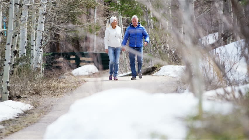 Aspen Colorado Caucasian male female couple seniors Rockies mountains vacation winter tourism promotion resort medical walking RED DRAGON