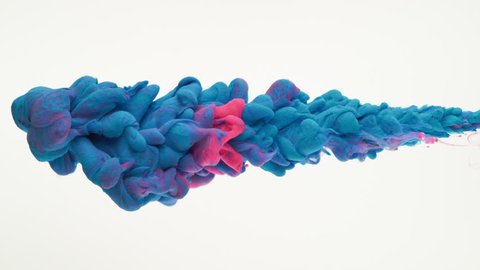 Close-up pink and blue ink being poured into water. Shot with high speed camera, phantom flex 4K. Slow Motion.