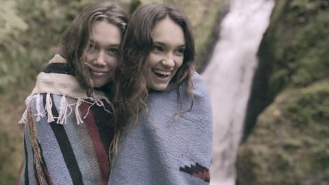 2 Friends Share A Blanket Together, They Laugh And Enjoy Nature Together (Slow Motion)