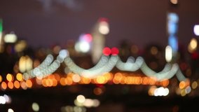 Illuminated suspension bridge in modern city out of focus at night - Powered by Shutterstock - Get 15% off with code: PIKWIZARD15
