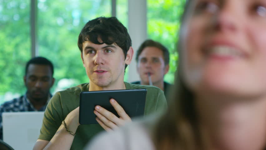 4K Group of students in class together, listening to the teacher and asking questions. Shot on RED Epic.