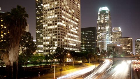 timelapse of traffic on freeway in downtown los angeles at night