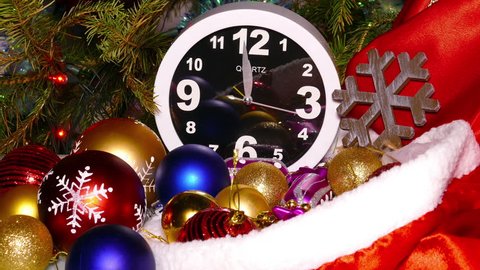 Clock and christmas balls and toys in a red bag