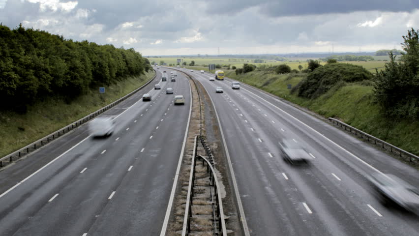 Timelapse of traffic on both carriageways of a British motorway. Easily flipped