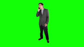 Businessman using a smartwatch on his wrist on a green screen chroma key background easy to replace with your content. Shot in 4K UHD resolution. - Powered by Shutterstock - Get 15% off with code: PIKWIZARD15