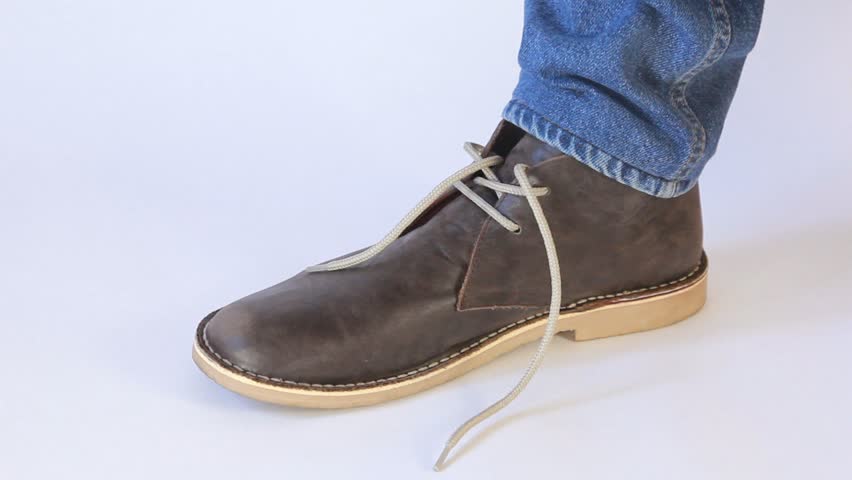 Young Man To Tie The Laces In Shoes