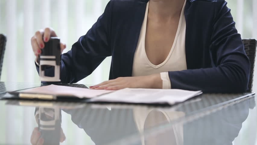 Attractive african american business woman puts a seal on the contract. Slow motion. Close up Royalty-Free Stock Footage #12367433