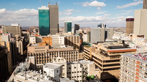 A slow panning timelapse across the city centre of Johannesburg (CBD) in the daytime with bright blue skies and cumulous clouds showing the High Court(Johannesburg, Gauteng, South Africa - 25/07/2015)