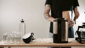 Close up of a barista making coffee. Grinding coffee beans