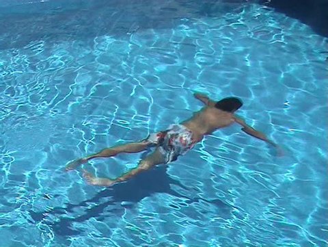 Youngster swimming in the swimming pool