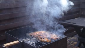 Chiken meat on barbeque grill smoke