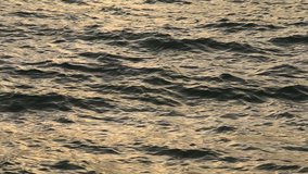 Black waves sea water background at sunset