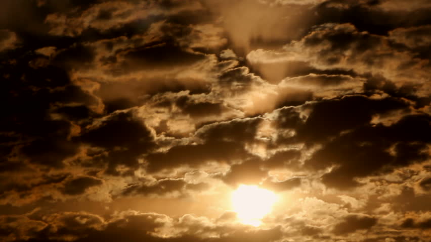 The sun ripples through layers of clouds as it rises in sepia-toned, morning sky. 1080p | Shutterstock HD Video #1239757